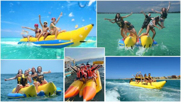 Bright yellow banana boat bounces across the waves as a group of friends hold on, laughing and splashing at Baga Beach