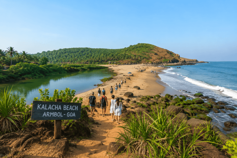 Kalacha Beach Goa near Arambol with visitors walking on the coastal path, Sweet Water Lake side, green hill view and rocky shoreline