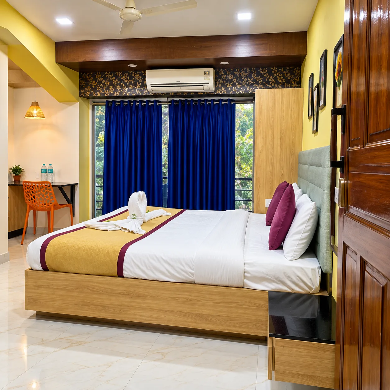 Air-conditioned deluxe room with double bed, work desk and large windows at Resorte Village Royale Goa