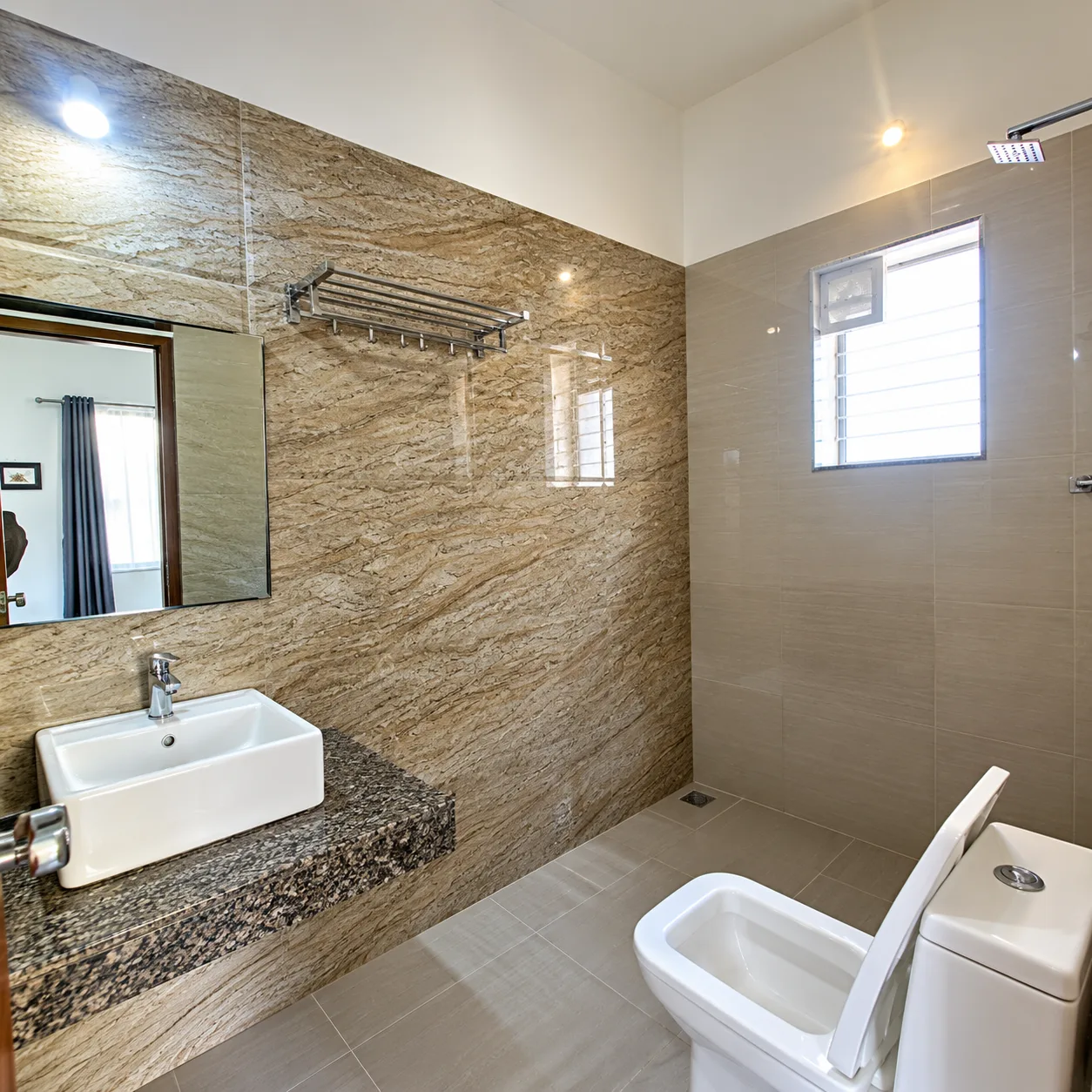 Clean attached bathroom with wash basin and shower in Resorte Village Royale deluxe room