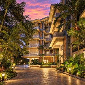 Entrance driveway of WS Grand Resort with resort building and palm trees in Sangolda North Goa