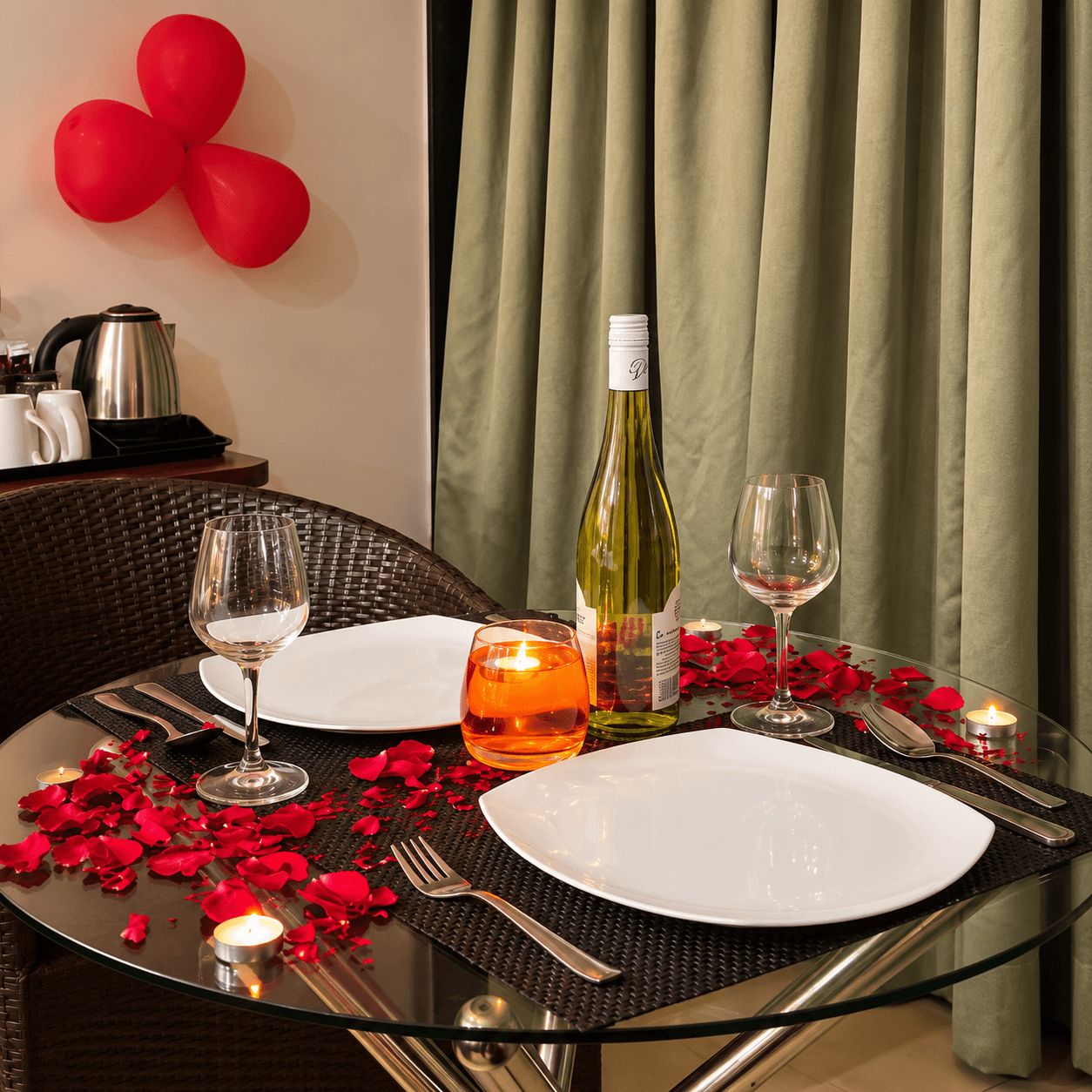 Candle light dinner for two with wine bottle and rose petals in honeymoon room at Resorte Village Royale