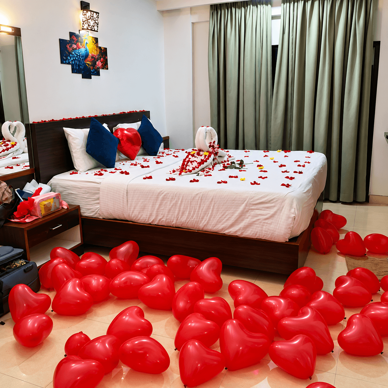 Romantic room setup with heart balloons and rose petals for honeymoon couple at Resorte Village Royale Goa